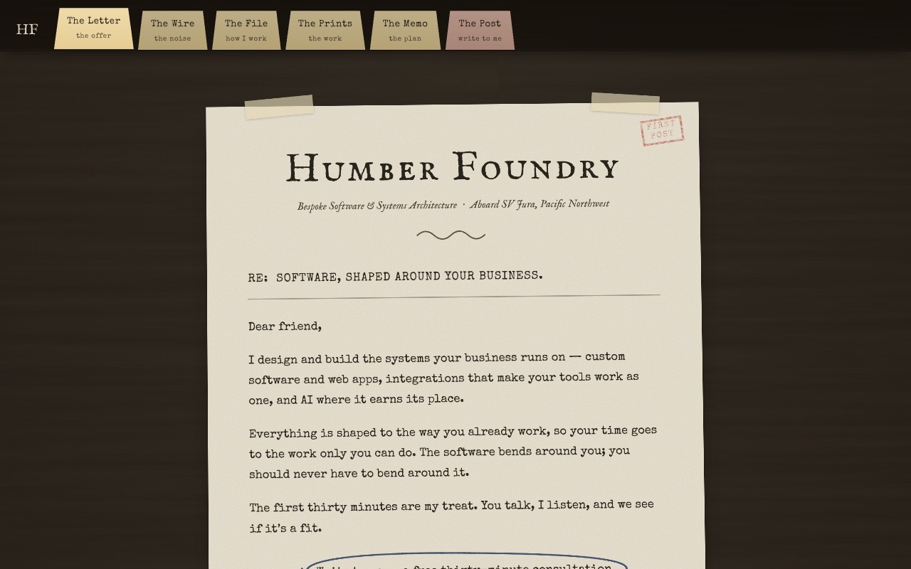 The Analogue Edition — a typewritten letter on letterhead, taped to a walnut desk
